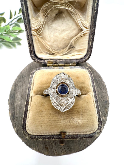 A sapphire and diamond openwork ring in platinum with a yellow gold ring shank, in an antique ring box