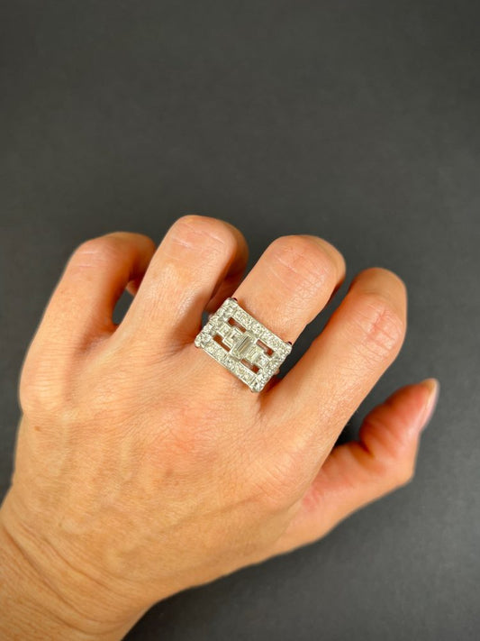 Vintage diamond and ruby buckle cocktail ring in platinum.