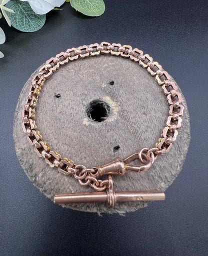 A fancy link rose gold bracelet with a T-bar and dog clip clasp