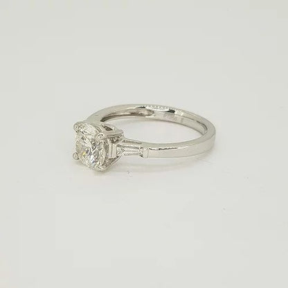 1.09ct Solitaire Diamond Engagement Ring, with 0.15cts tapered baguette-cut diamond set shoulders. Mounted in platinum
