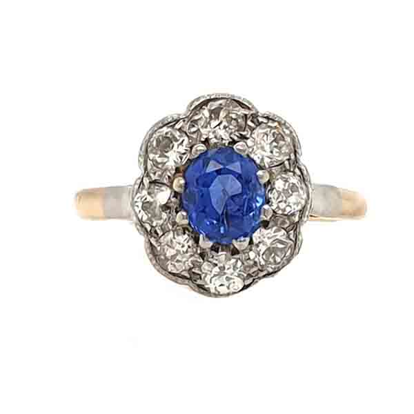 Antique Ceylon Sapphire and Old Cut Diamond Cluster Ring; 0.80ct oval cornflour blue sapphire surrounded by 0.80cts old mine cut diamonds, in platinum and 18ct yellow gold, Circa 1900