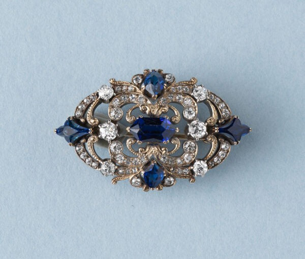 Antique Victorian 3.77ct Sapphire and Diamond Brooch; mixed cut sapphires accented with 1.52cts old-cut diamond set swirls. 19th century.