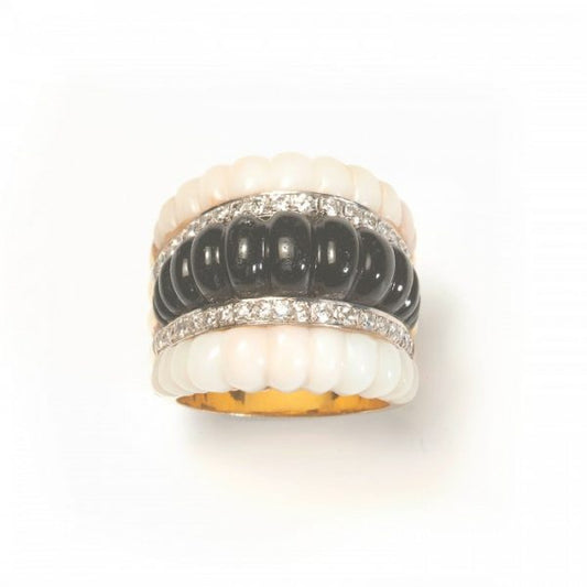 Vintage Coral, Black Onyx and Diamond Ring, central row of carved ribbed black onyx flanked by diamond-set rows and ribbed carved angel skin coral to the outer edges, in 14ct yellow gold, Circa 1980