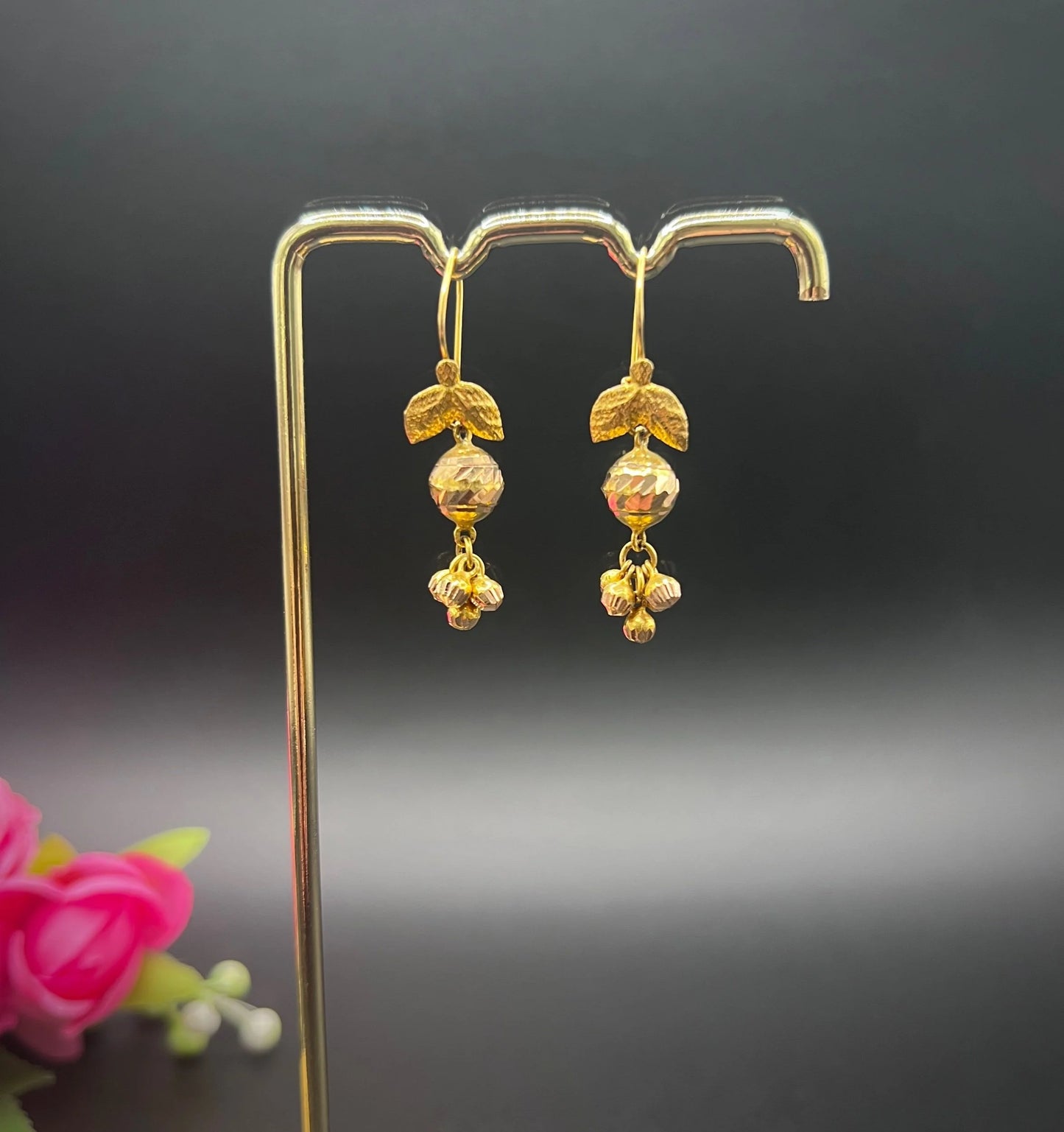 A pair of yellow gold leaf and faceted ball drop earrings with hook fittings