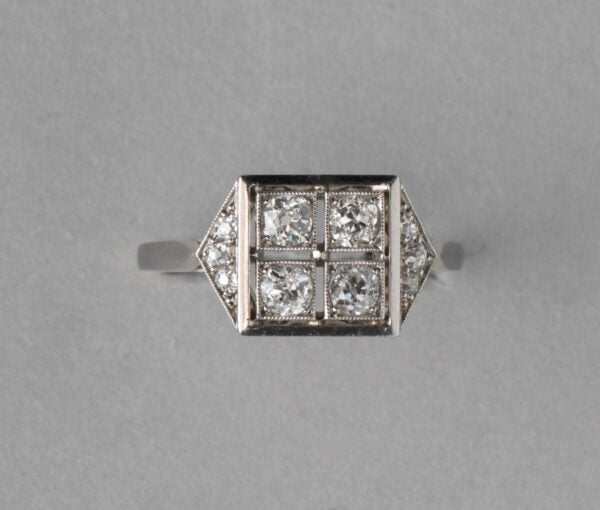 Art Deco French 0.70ct Old Cut Diamond and Platinum Square Ring; four old cut diamonds, flanked by diamond-set triangle shoulders, Numbered, Circa 1920