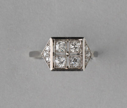 Art Deco French 0.70ct Old Cut Diamond and Platinum Square Ring; four old cut diamonds, flanked by diamond-set triangle shoulders, Numbered, Circa 1920