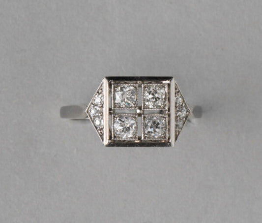 Art Deco French 0.70ct Old Cut Diamond and Platinum Square Ring; four old cut diamonds, flanked by diamond-set triangle shoulders, Numbered, Circa 1920