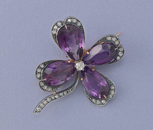 Art Nouveau Amethyst and Diamond Four Leaf Clover Brooch; four pear-shaped amethysts around an old cut diamond, with rose cut diamond accents
