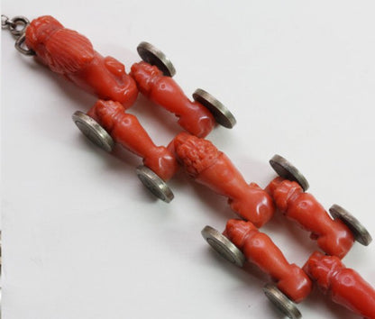 Antique Georgian Coral Bracelet; with ten carved animal coral links of a lion, dogs, dragons head and tail, with gold charm lock, 19th century
