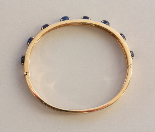 Vintage Sapphire, Diamond and 18ct Yellow Gold Bangle Bracelet; set with 7.00cts oval cabochon sapphires and 0.42cts brilliant cut diamonds