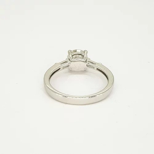 1.09ct Solitaire Diamond Engagement Ring, with 0.15cts tapered baguette-cut diamond set shoulders. Mounted in platinum