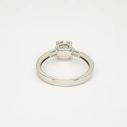 1.09ct Solitaire Diamond Engagement Ring, with 0.15cts tapered baguette-cut diamond set shoulders. Mounted in platinum