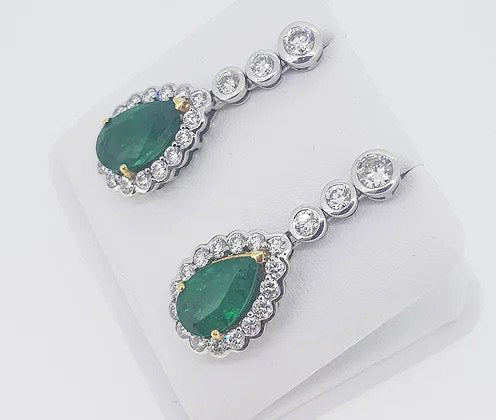 Fine pair of Emerald and Diamond Pear Shaped Cluster Drop Earrings; 6.13cts emeralds, surrounded by 2.67cts sparkling diamonds, in 18ct gold