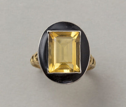 Art Deco French Citrine and Black Enamel Ring; featuring a large step cut citrine that pops from a black enamel frame, set in silver to 18ct yellow gold gallery and shank, Circa 1920