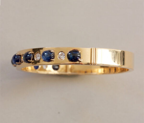 Vintage Sapphire, Diamond and 18ct Yellow Gold Bangle Bracelet; set with 7.00cts oval cabochon sapphires and 0.42cts brilliant cut diamonds. Italy, Circa 1980