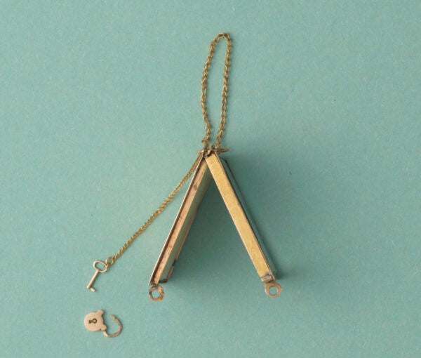 Early 19th Century Georgian French 18ct Gold Angel Locket; black and gold gilded angel picking roses, miniature key and lock, Circa 1809-1819