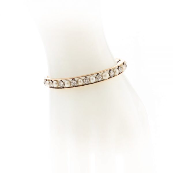 Antique Edwardian Natural Pearl and Old Cut Diamond Bangle Bracelet; set with certified natural saltwater pearls and 2.75cts old cut diamonds, in 15ct gold and platinum