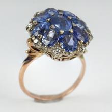 Vintage 8.90ct Sapphire and Diamond Cluster Ring; nine oval sapphires in a floral design, accented with brilliant cut diamonds, in 18ct white and rose gold