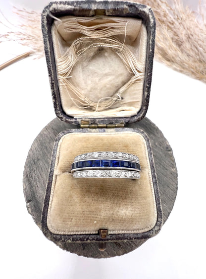 A platinum night and day flip band ring set with diamonds, sapphires and rubies, in a ring box