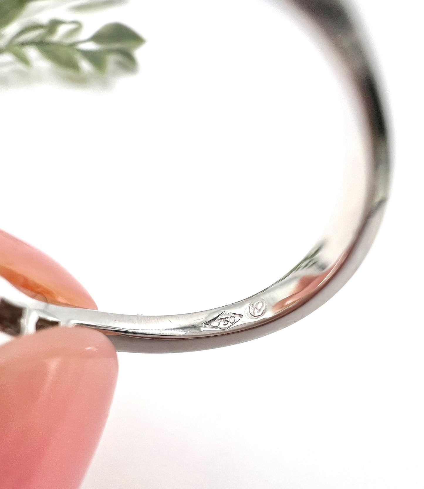 Close-up of a 750 stamp inside a white gold ring shank