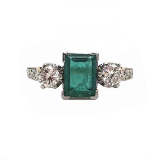 Vintage Emerald and Diamond Three Stone Engagement Ring; 0.60ct baguette-cut emerald flanked by brilliant cut diamonds, diamond set shoulders, 18ct yellow gold, Circa 1940s