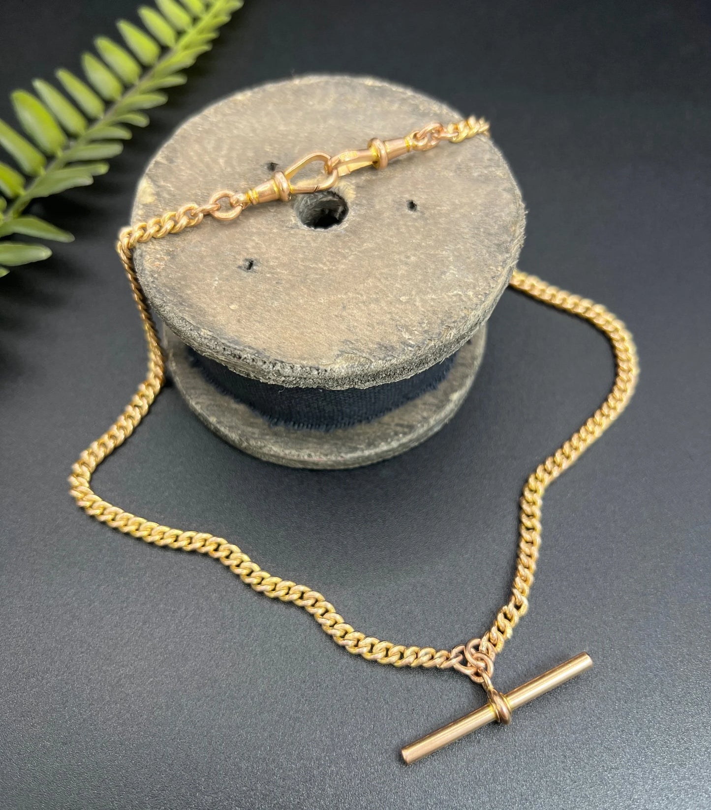 A yellow gold curb link Albert watch chain