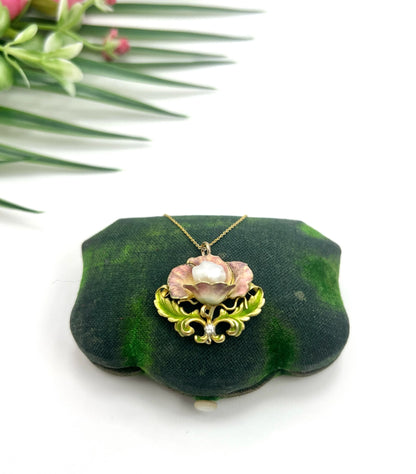An enamel, diamond and pearl flower pendant with a gold chain