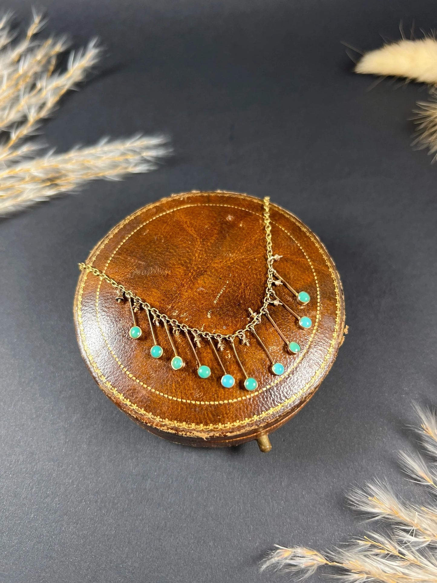 A gold negligee pendant necklace with turquoise drops