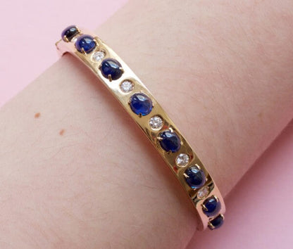 Vintage Sapphire, Diamond and 18ct Yellow Gold Bangle Bracelet; set with 7.00cts oval cabochon sapphires and 0.42cts brilliant cut diamonds. Italy, Circa 1980