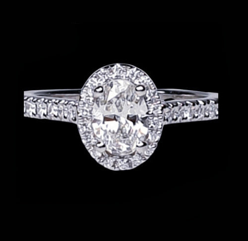 Diamond Oval Cluster Engagement Ring; GIA certified 0.50 carat F colour SI1 clarity oval faceted with diamond surround and diamond-set shoulders, in Platinum