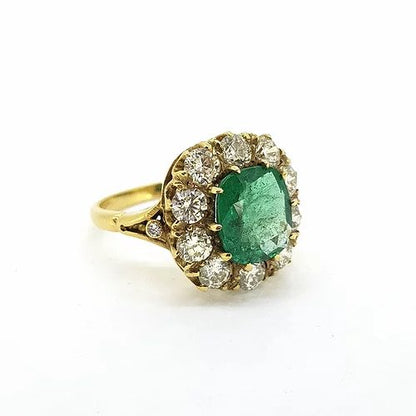 Victorian Style Emerald and Old Cut Diamond Cluster Ring; featuring a central 2.50ct cushion cut emerald surrounded by 2.00cts old-cut diamonds, in 18ct yellow gold