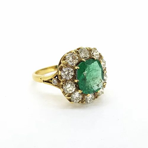 Victorian Style Emerald and Old Cut Diamond Cluster Ring; featuring a central 2.50ct cushion cut emerald surrounded by 2.00cts old-cut diamonds, in 18ct yellow gold