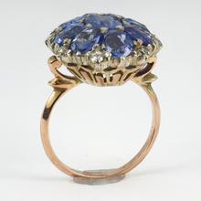 Vintage 8.90ct Sapphire and Diamond Cluster Ring; nine oval sapphires in a floral design, accented with brilliant cut diamonds, in 18ct white and rose gold