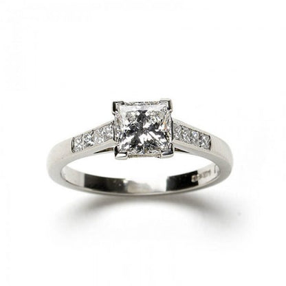 A diamond engagement ring, set with a 1.03 carat, F colour, VS1 clarity, princess-cut diamond, diamond set shoulders, in platinum, with GIA certificate.