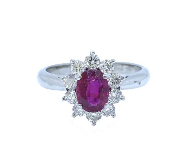 Mozambique Ruby and Diamond Oval Cluster Ring; 1.11 carat oval faceted ruby with no heat treatments surrounded by ten round brilliant-cut diamonds, in 18ct white gold