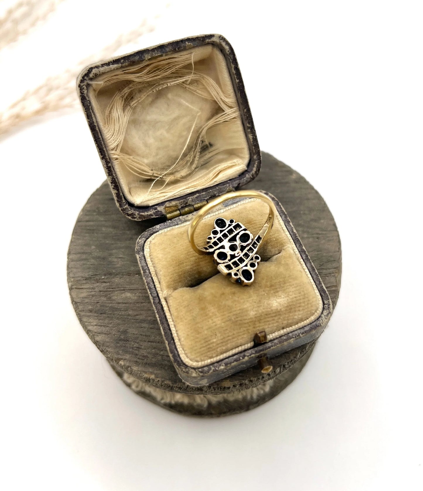 A navette shaped sapphire and diamond ring in yellow gold, in an antique ring box