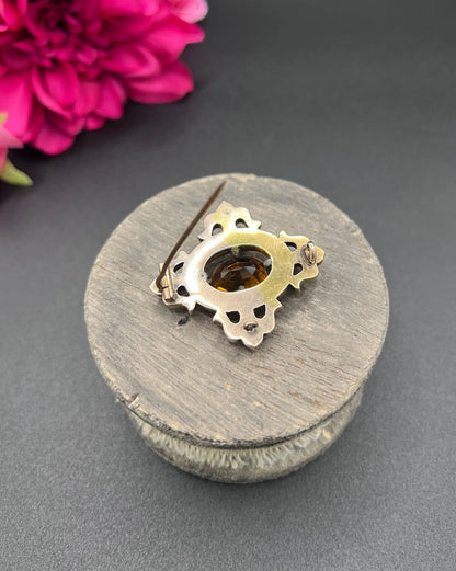 A yellow gold, oval citrine and agate ornate brooch