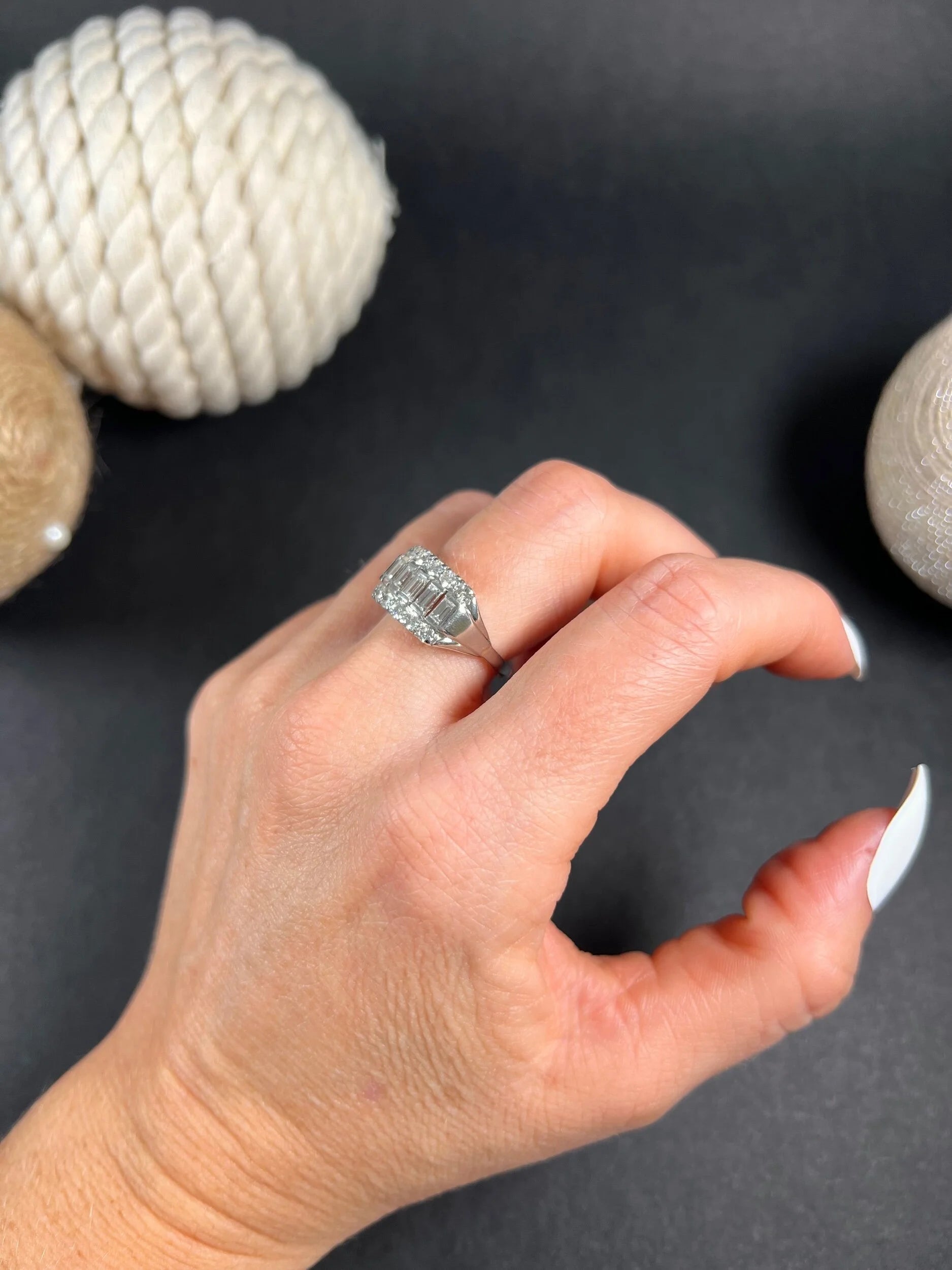 A three row diamond band ring in platinum modelled on a hand