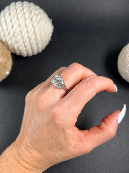 A three row diamond band ring in platinum modelled on a hand