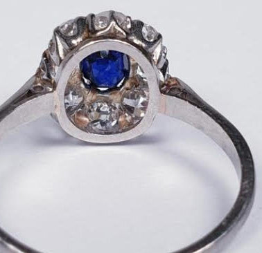 Art Deco Sapphire and Diamond Cluster Engagement Ring; 0.60ct royal blue oval cut sapphire surrounded by 0.80cts old cut diamonds