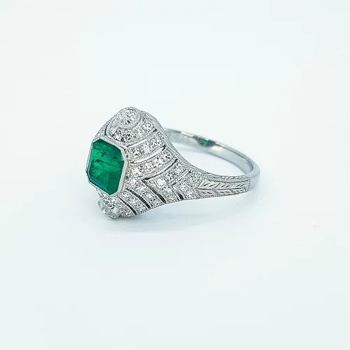 Art Deco Style Colombian Emerald and Diamond Domed Cocktail Ring; octagonal cut emerald surrounded by diamonds in a pierced domed mount, in platinum