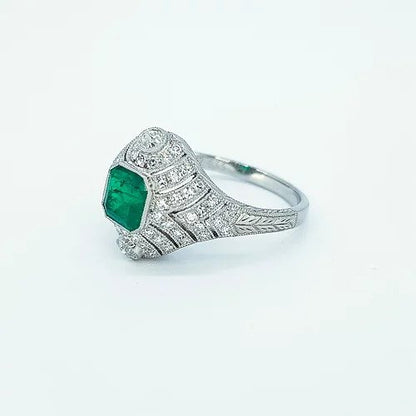 Art Deco Style Colombian Emerald and Diamond Domed Cocktail Ring; octagonal cut emerald surrounded by diamonds in a pierced domed mount, in platinum