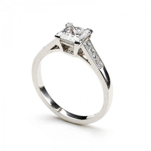 A diamond engagement ring, set with a 1.03 carat, F colour, VS1 clarity, princess-cut diamond, diamond set shoulders, in platinum, with GIA certificate.