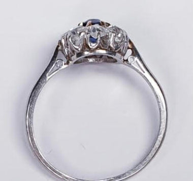Art Deco Sapphire and Diamond Cluster Engagement Ring; 0.60ct royal blue oval cut sapphire surrounded by 0.80cts old cut diamonds