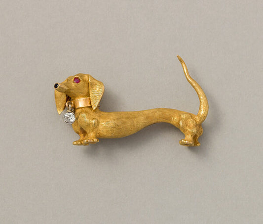 Vintage 18ct Yellow Gold Dachshund Dog Brooch, with matte striped fur and polished collar with dangling old cut diamond, an onyx nose and ruby eyes. French, Circa 1960
