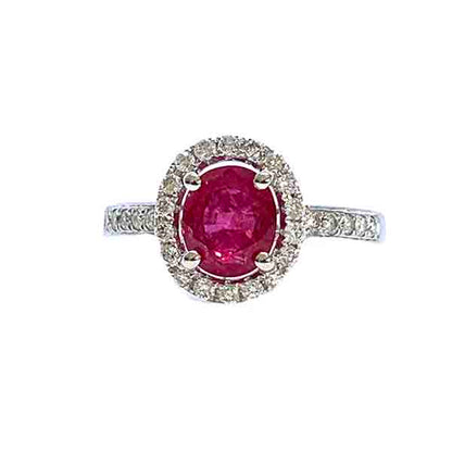 Ruby and Diamond Halo Cluster Engagement Ring; 1.71ct oval ruby with no indication of heat treatment with diamond halo and diamond shoulders, 18ct white gold