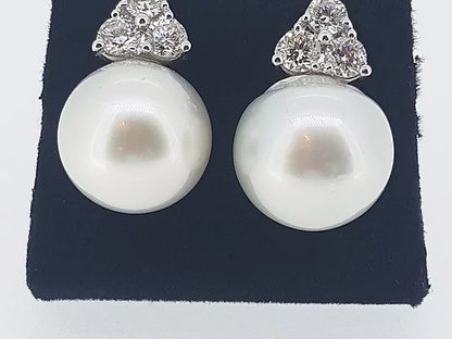 South Sea Pearl and Diamond Trefoil Earrings; 15mm South Sea pearls accented with 1.70ct trefoil diamond tops, 18ct white gold