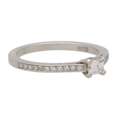 Modern Emerald Cut Diamond Ring With Diamond Shoulders in Platinum