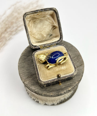 A yellow gold cat brooch with a lapis lazuli body, in an antique box