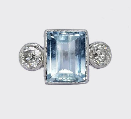Aquamarine and Diamond Three Stone Ring; central 3.04ct rectangular step-cut aquamarine flanked by two brilliant cut diamonds, collet-set, 18ct white gold.